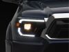 Raxiom 12-15 Toyota Tacoma Axial Series Switchback Projector Headlights- Black Housing- Clear Lens